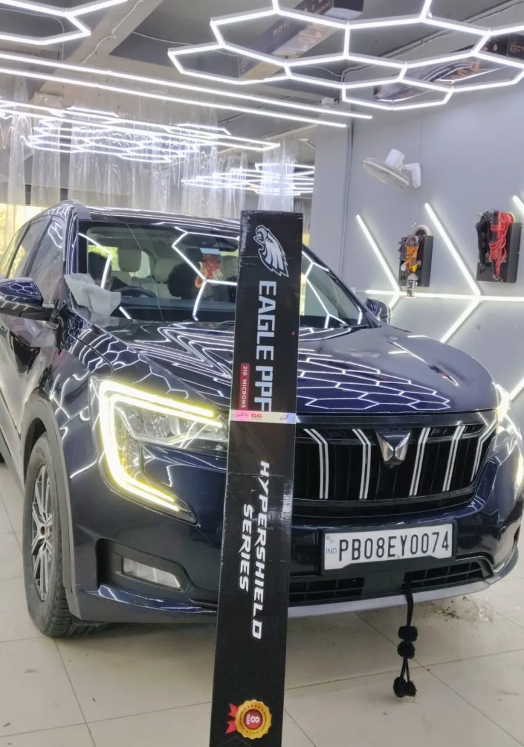 EAGLE PPF HyperShield Series roll beside a freshly protected SUV