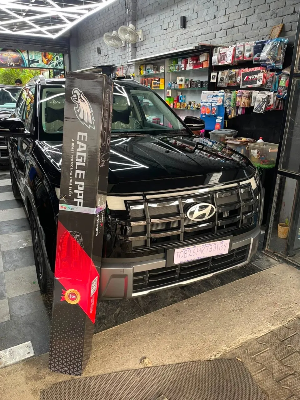 EAGLE PPF Standard Series roll beside a gloss black SUV